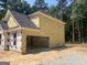 Attached garage exterior view showing siding, roof and building materials nearby at 5565 Hwy 155, Stockbridge, GA 30281