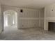 Living room featuring a fireplace, arched doorway, and bright window, creating a cozy space at 5565 Hwy 155, Stockbridge, GA 30281