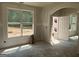 Bright living room featuring large windows and an arched doorway, awaiting its final touches at 5565 Hwy 155, Stockbridge, GA 30281