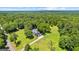 Aerial view of home nestled among mature trees with large yard at 152 Bear Creek Rd, Moreland, GA 30259