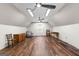 Spacious attic featuring modern lighting, wood flooring, a ceiling fan, and ample room for customization at 152 Bear Creek Rd, Moreland, GA 30259