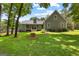 Expansive backyard with well-maintained lawn and mature trees, complemented by a cozy back porch at 152 Bear Creek Rd, Moreland, GA 30259