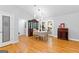Bright dining room with hardwood floors, modern lighting, and seamless transition to the kitchen at 152 Bear Creek Rd, Moreland, GA 30259