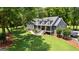 Inviting gray home boasts lush landscaping, mature trees, and a spacious driveway, perfect for outdoor enjoyment at 152 Bear Creek Rd, Moreland, GA 30259