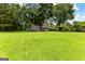 Spacious front yard showcases a well-maintained lawn and a charming gray home at 152 Bear Creek Rd, Moreland, GA 30259
