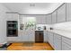 Updated kitchen with stainless appliances, modern backsplash, and hardwood flooring at 152 Bear Creek Rd, Moreland, GA 30259