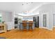 Well-lit kitchen featuring hardwood floors, stainless steel appliances, and a center island at 152 Bear Creek Rd, Moreland, GA 30259