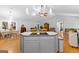Open-concept kitchen island flows into living and dining areas with hardwood flooring at 152 Bear Creek Rd, Moreland, GA 30259