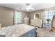 Main bedroom with neutral walls, patterned quilt, and abundant natural light from a big window at 152 Bear Creek Rd, Moreland, GA 30259