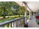 Inviting porch offers a relaxing view of the meticulously landscaped front yard and mature trees at 152 Bear Creek Rd, Moreland, GA 30259