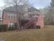 Backyard of brick house with a deck and stairs at 145 Mill Run, Fayetteville, GA 30214