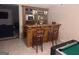 Home bar with custom cabinets, shelving and barstool seating area at 145 Mill Run, Fayetteville, GA 30214