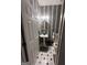Powder room with decorative wallpaper, pedestal sink, and black and white flooring at 145 Mill Run, Fayetteville, GA 30214