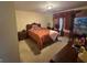 Cozy bedroom featuring warm lighting, carpet flooring, and a comfortable bed at 145 Mill Run, Fayetteville, GA 30214