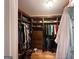 Walk-in closet with custom wood shelving, shoe racks, and hanging rods at 145 Mill Run, Fayetteville, GA 30214