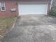 Long concrete driveway leading to the side-entry garage of the house at 145 Mill Run, Fayetteville, GA 30214