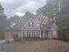 Charming two-story home with a well-maintained lawn and a welcoming front porch at 145 Mill Run, Fayetteville, GA 30214