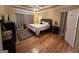 Spacious main bedroom with hardwood floors, a ceiling fan, and private bath at 145 Mill Run, Fayetteville, GA 30214