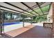 A covered brick patio offers views of a backyard with seating and a pool at 234 Crumbley Rd, Mcdonough, GA 30252