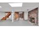 Unfinished basement featuring a brick fireplace, open stairs, and potential for customization at 234 Crumbley Rd, Mcdonough, GA 30252