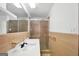 Bathroom with tiled walls, sleek sink, shower with glass doors, and plenty of natural light at 234 Crumbley Rd, Mcdonough, GA 30252