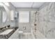 Bathroom featuring a vanity, toilet, and combination shower and tub with marble patterned tile at 234 Crumbley Rd, Mcdonough, GA 30252