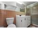 Bathroom with tiled walls, a sleek sink, and shower with glass doors at 234 Crumbley Rd, Mcdonough, GA 30252