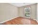 Bedroom featuring hardwood floors and a sunlit window at 234 Crumbley Rd, Mcdonough, GA 30252