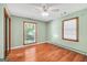 Bedroom featuring natural light, a ceiling fan and a mirrored closet at 234 Crumbley Rd, Mcdonough, GA 30252