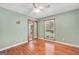 Bright bedroom features wooden floors, a window, and a mirrored closet at 234 Crumbley Rd, Mcdonough, GA 30252