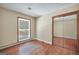 Bedroom features hardwood floors, closet with mirror and window at 234 Crumbley Rd, Mcdonough, GA 30252