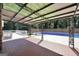 Covered brick patio overlooking a spacious backyard with a sparkling blue swimming pool at 234 Crumbley Rd, Mcdonough, GA 30252