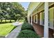 Brick house with a covered front porch, green bushes, and column accents at 234 Crumbley Rd, Mcdonough, GA 30252