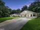 Charming home featuring manicured lawn, porte-cochère, and long driveway at 234 Crumbley Rd, Mcdonough, GA 30252