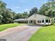Charming home featuring manicured lawn, porte-cochère, and long driveway at 234 Crumbley Rd, Mcdonough, GA 30252