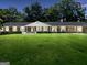 Home showcasing a beautifully landscaped front yard with a well-maintained lawn at 234 Crumbley Rd, Mcdonough, GA 30252