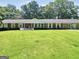 Home showcasing a beautifully landscaped front yard with a well-maintained lawn at 234 Crumbley Rd, Mcdonough, GA 30252