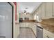 Well-lit kitchen with white cabinets, stainless steel appliances, and tiled flooring at 234 Crumbley Rd, Mcdonough, GA 30252