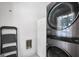 Bright laundry room featuring modern washer/dryer, utility sink and ladder at 234 Crumbley Rd, Mcdonough, GA 30252