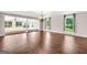 Open-concept living room featuring hardwood floors, decorative lighting, and outdoor views at 234 Crumbley Rd, Mcdonough, GA 30252