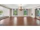 Spacious living room featuring hardwood floors, decorative lighting, and multiple windows at 234 Crumbley Rd, Mcdonough, GA 30252