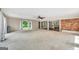 Spacious living room featuring light carpet, a ceiling fan and exposed brick accent wall at 234 Crumbley Rd, Mcdonough, GA 30252