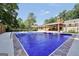 Refreshing in-ground pool featuring a concrete patio and covered lounge area, perfect for outdoor entertaining at 234 Crumbley Rd, Mcdonough, GA 30252