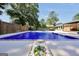 Inviting in-ground pool with sleek tile and stone trim surrounded by concrete, set in a spacious fenced-in backyard at 234 Crumbley Rd, Mcdonough, GA 30252