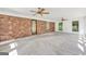 Bright sun room with brick accent wall, neutral carpet, and multiple windows at 234 Crumbley Rd, Mcdonough, GA 30252