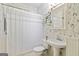 This bathroom has unique wallpaper, a pedestal sink, and an enclosed tub and shower at 1166 Virginia Avenue Northeast Ne Ave # 8, Atlanta, GA 30306