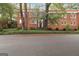 Apartment exterior with a brick facade and mature trees surrounding the property at 1166 Virginia Avenue Northeast Ne Ave # 8, Atlanta, GA 30306