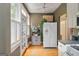 Bright kitchen featuring white cabinets, double door refrigerator and natural light from door and windows at 1166 Virginia Avenue Northeast Ne Ave # 8, Atlanta, GA 30306