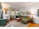 Bright living room with an olive sofa, hardwood floors, and lush green plants at 1166 Virginia Avenue Northeast Ne Ave # 8, Atlanta, GA 30306