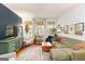 Inviting living room with green sofa, wood floors, and lots of natural light at 1166 Virginia Avenue Northeast Ne Ave # 8, Atlanta, GA 30306